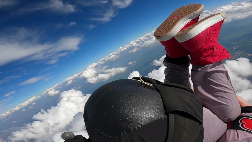 Skydiver turning and entering the clouds. Royalty-Free Stock Footage #1096210685