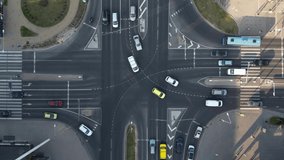 Top down aerial of cars drive at cross road. Traffic highway transportation. Compliance with traffic Rules. City life, public transportation concept. Multilane road. Summer evening, sun shining. 