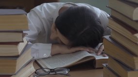 Student Girl Napping And Sleeping On Desk With Books In Library.
