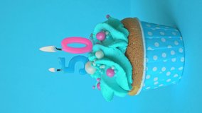 Birthday cupcake with cream on a blue background. Burning Candles 50. Blow out the candles. Happy Anniversary. - Powered by Shutterstock - Get 15% off with code: PIKWIZARD15