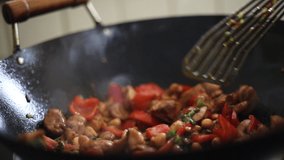 Stir frying a chicken and vegetable dish in a seasoned wok - Powered by Shutterstock - Get 15% off with code: PIKWIZARD15