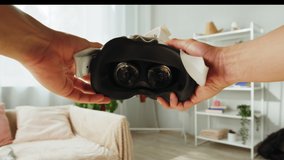 Korean man showing virtual reality glasses POV, playing video games, Asian guy gamer wearing new generation gaming headset for entertainment at home, future technology concept. - Powered by Shutterstock - Get 15% off with code: PIKWIZARD15