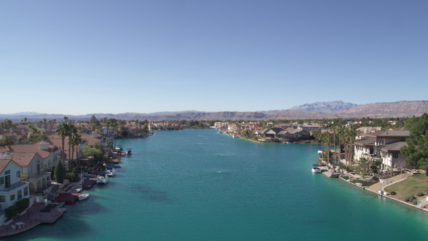 Low aerial through West Sahara Las Vegas gated community turquoise lake