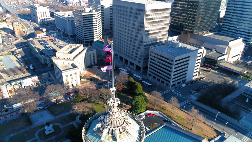 Aerial Tilt Down Shot Of National Flags On Government Building In Residential City During Sunny Day - Nashville, Tennessee
