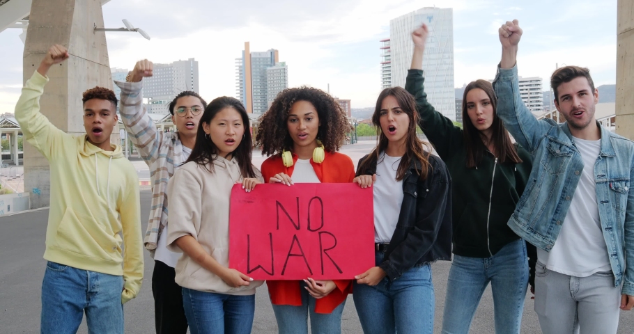 Group of diverse young people protesting against the war. Pacifism, students against the war