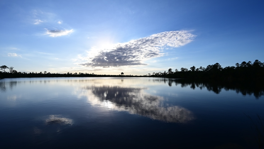 Timelapse of sunset cloudscape over Pine Glades Lake in Everglades National Park, Florida 4K.