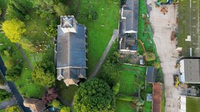 High altitude drone shot above a countryside church in England