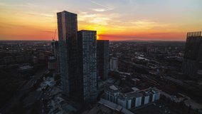 Establishing Aerial View Shot of Manchester UK, City Skyline England United Kingdom, wonderful sunset, tracking right