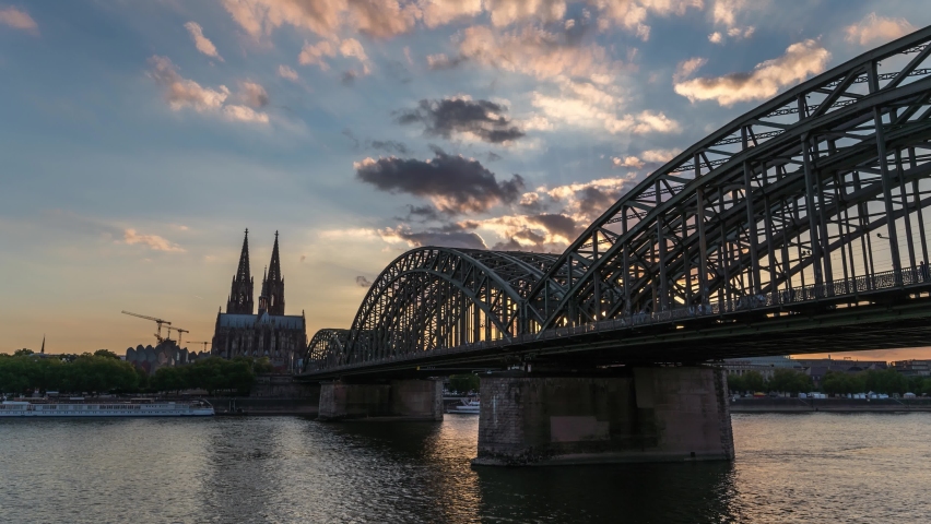 Cologne (Köln) Germany time lapse 4K, city skyline day to night sunset timelapse at Cologne Cathedral (Cologne Dom) with Rhine River and Hohenzollern Bridge Royalty-Free Stock Footage #1096240763