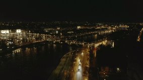 Aerial footage of evening city. Vehicles driving on Pont de la Concorde and Seine river waterfronts. Paved square Place de la Concorde with Luxor Obelisk in middle. Paris, France