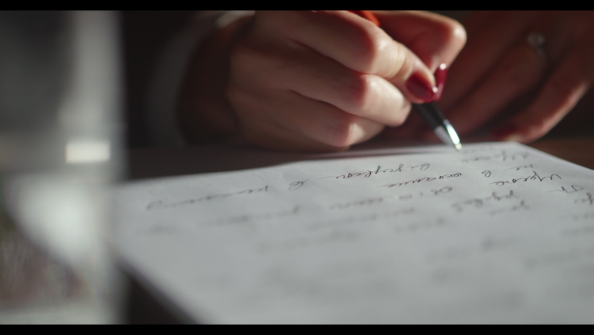 Close-up female hands write private letter on white paper, red pen and manicure. Tender woman hands, working-studying process, planning or writing wishes, writing greetings. High quality 4k footage Royalty-Free Stock Footage #1096246791