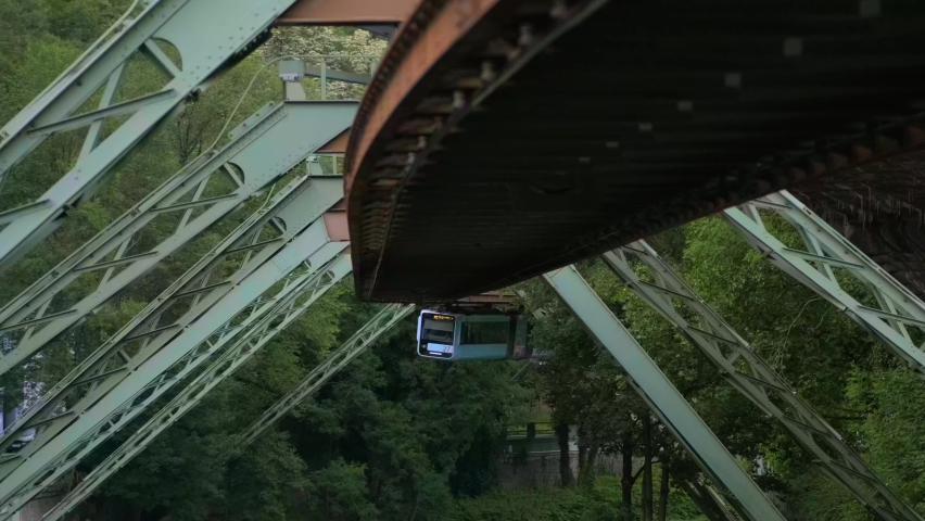  Wuppertal Suspension Railway.  The carriage rides in the background of summer green trees close-up. Royalty-Free Stock Footage #1096250209