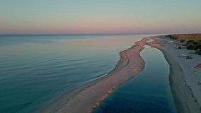 drone flight over sea shore of island in black sea at sunrise. Outdoor adventure travel to beautiful beach. Cinematic wild nature aerial 4K. transparent calm sea waters. clip has noise