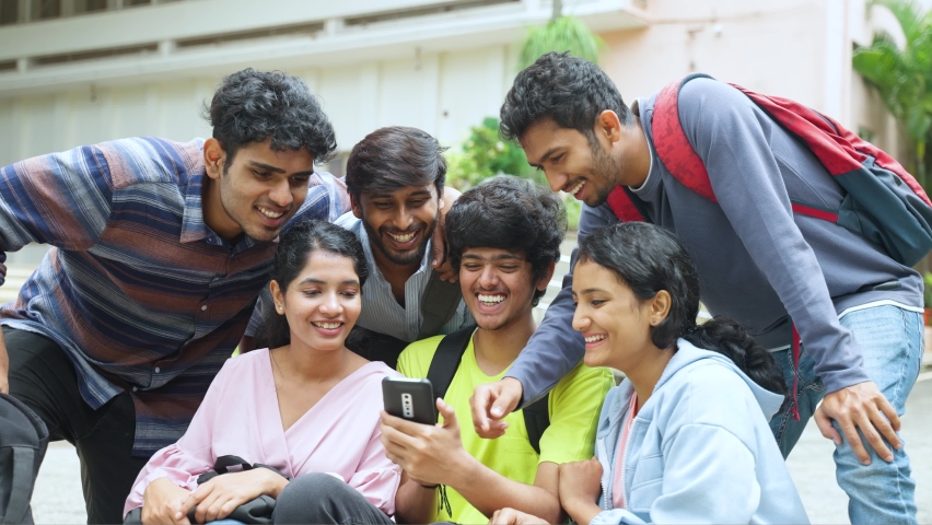 group of happy smiling stundets busy wathcing mobile phone during break time - concept of social media sharing, internet and entertainment Royalty-Free Stock Footage #1096251495