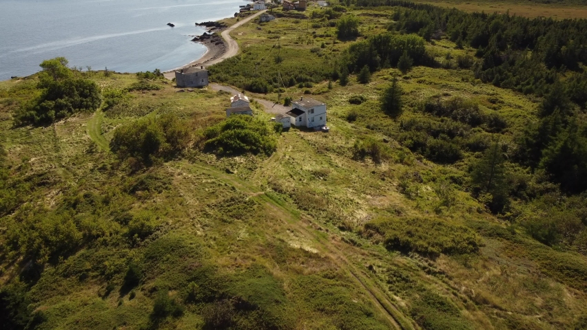Aerial rustic homestead and small fishing community of Summerville Newfoundland on the Bonavista Peninsula.
