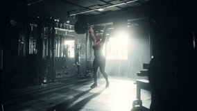 Professional Female Powerlifter Lifting Heavy Weights and Dropping Them in a Dark Gym. Portrait of an Athletic Woman Does a Barbell Lift. Extreme Workout, Exercise, Championship Training. Slow Motion - Powered by Shutterstock - Get 15% off with code: PIKWIZARD15