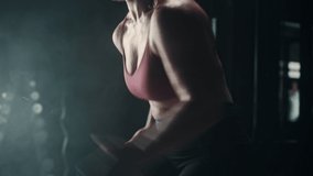 An Energetic Female Athlete Running in Place as a Cardio Exercise for Daily Workout in a Dark Gym. An Agile Future Roadrunner Training Hard For the Next Competition. Dynamic Tracking Shot - Powered by Shutterstock - Get 15% off with code: PIKWIZARD15