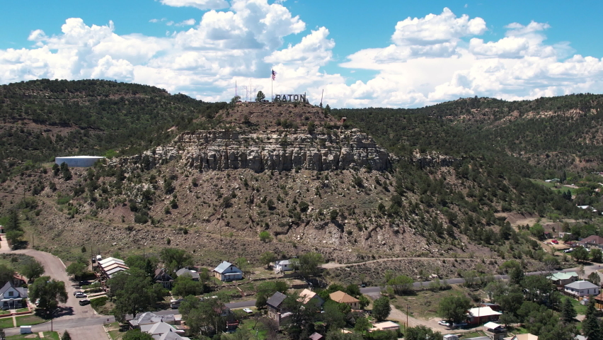 Raton, New Mexico USA, Aerial View of Landmark Sign on Hill Above Town, Drone Shot