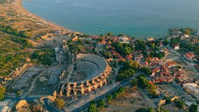 scenic drone shot of the ancient city of Side, Turkey. The largest amphitheater in Turkey. The main street of the ancient city and Mediterranean Sea. High quality 4k footage