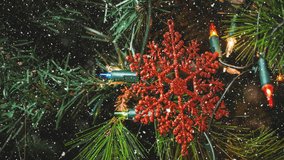 Animation of snow falling over christmas tree and decorations. christmas, tradition and celebration concept digitally generated video.