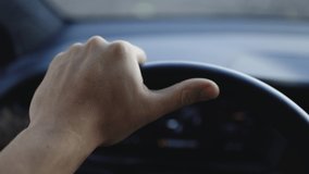 Close up of man hand on vehicle steering wheel as he is driving. Male driving a car in the highway, hands move on the wheel. Unrecognizable businessman putting his hands on steering wheel of car. - Powered by Shutterstock - Get 15% off with code: PIKWIZARD15