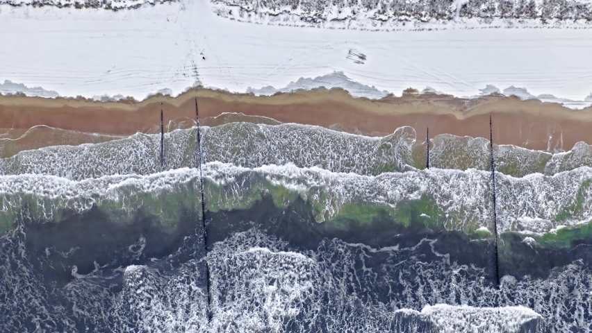 Hel peninsula at winter with snow on beach, Baltic Sea, Poland, aerial view
