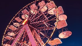 Funfair ferris wheel at night. Ferris wheel and rollercoaster in motion at amusement park at night. - Powered by Shutterstock - Get 15% off with code: PIKWIZARD15