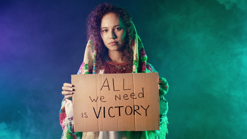Ukrainian woman with cardboard All we need is victory. Ukraine will win war. Protest, democracy, liberty, demonstration, russian aggresion concept Royalty-Free Stock Footage #1096294187