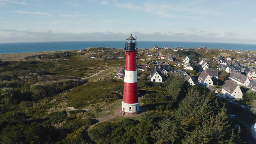 Sylt, Germany. Lighthouse in Hörnum, Schleswig-Holstein, North Sea. 4K drone. Beautiful tourist destination and attraction from above.