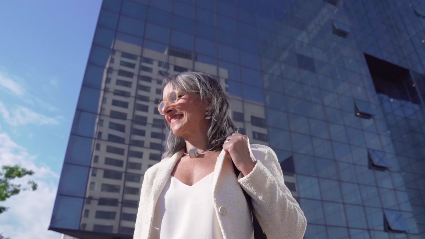 Middle-aged confident, focused and powerful business woman looking at camera. Beautiful mature lady smiling.