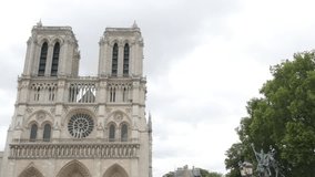 Notre-Dame Cathedral located in France capital Paris 4K 2160p UltraHD slow panning footage - Famous Notre Dame de Paris church by the day 4K 3840X2160 UHD pan  video