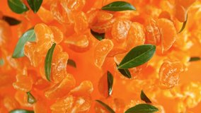 Super Slow Motion Shot of Peeled Tangerines and Green Leaves Flying Towards Camera at 1000fps. - Powered by Shutterstock - Get 15% off with code: PIKWIZARD15