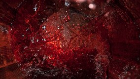 Super Slow Motion Shot of Red Wine Splashing in Old Oak Wooden Barrel at 1000fps.