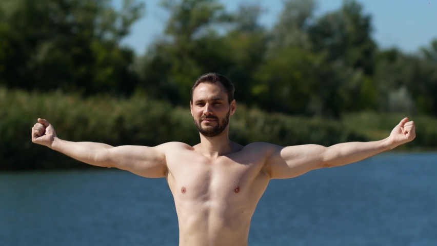 fitness trainer doing yoga on the lake. arm and back exercise concept: sport, fitness, health and lifestyle