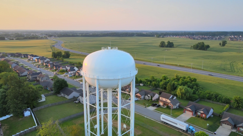 Pan Aerial shot of the watertower in Clarksville revealing a beautiful sunrise at the end Royalty-Free Stock Footage #1096307719