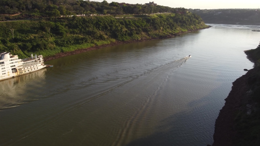 Aerial view of boat cruising on Iguazu River meeting Rio Parana and Triple Border between Argentina,Brazil and Paraguay.
