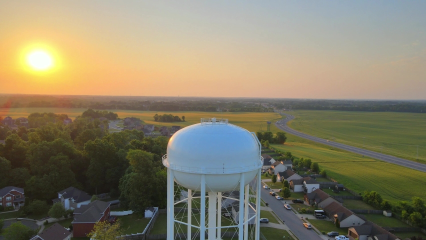 Aerial view rising over the watertower in Clarksville revealing a beautiful sunrise at the end Royalty-Free Stock Footage #1096308113