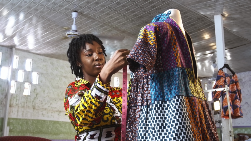 Female Black African Fashion Designer Measures and Records Parts of New Dress on Mannequin Royalty-Free Stock Footage #1096309081