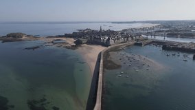 Môle des Noires lighthouse with Saint-Malo in background, Brittany in France. Aerial backward. Sky for copy space