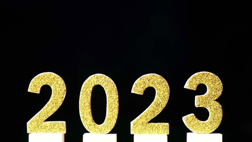 Shiny golden new year 2023 numbers on blinking defocused colorful lights background | Shutterstock HD Video #1096313459