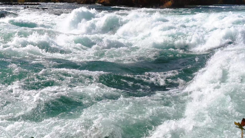 Niagara Falls from the American and Canadian sides. Rainbow over the waterfall. The most popular tourist place. Stormy river that flows into the lake.