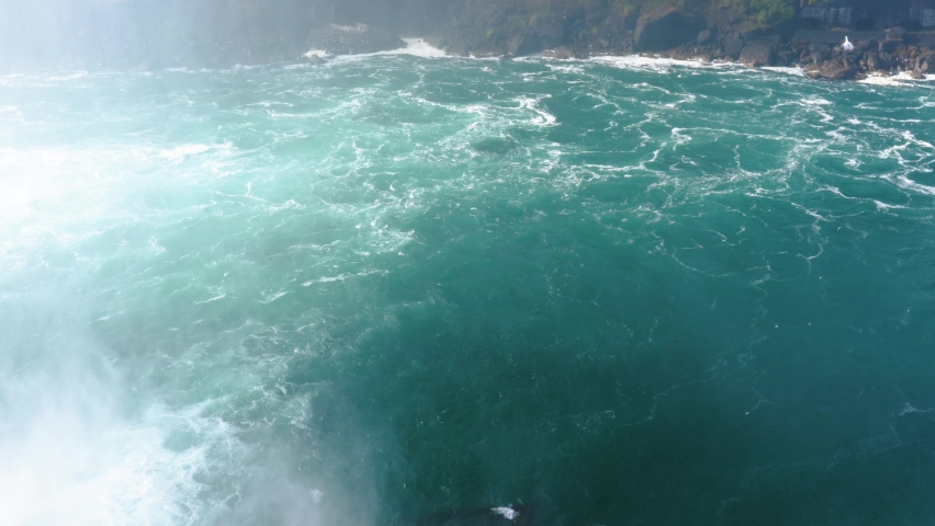Niagara Falls from the American and Canadian sides. Rainbow over the waterfall. The most popular tourist place. Stormy river that flows into the lake.