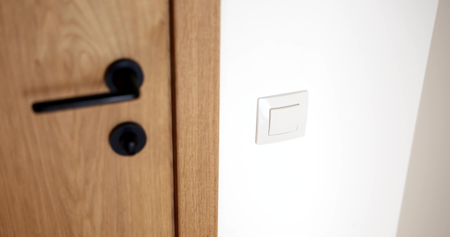 Woman enters bathroom and turns on light closeup