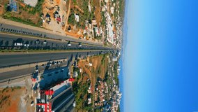 vertical aerial video of the long highway in Turkey, settlement near it. High quality 4k footage