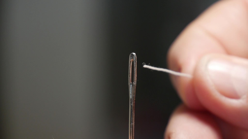Close Up Blurred Shooting with Taylor Inserting Sewing Thread in Needle Hole. Man Preparing Needle with Thread, Getting Ready for Homemade Sewing Activity.
 Royalty-Free Stock Footage #1096326321
