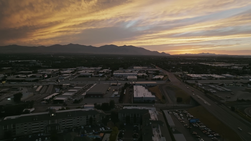 sunset with mountain Cars on the highway sunset behind the mountains Blue sky with orange thick cloud Clouds Beautiful building golden sun blue clouds Salt Lake City Utah Downtown