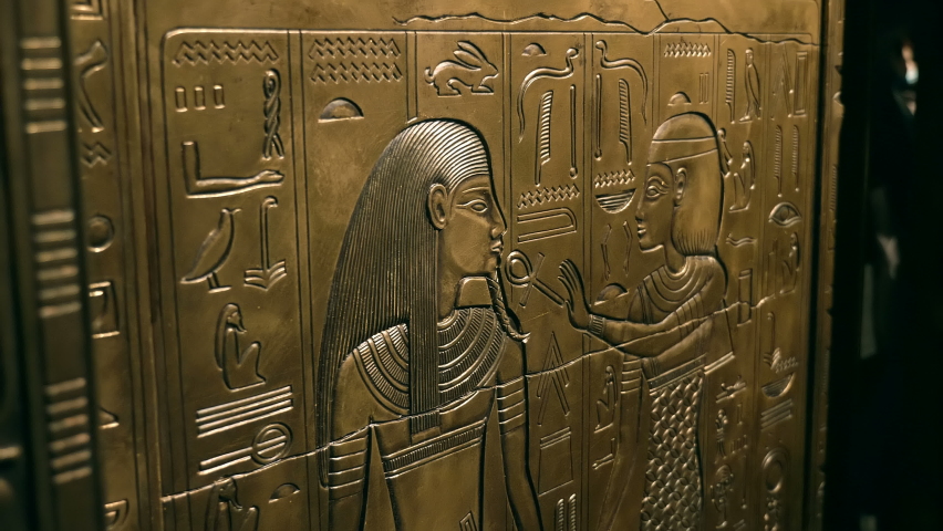 Golden ancient Egyptian frescoes on the walls of tombs and pyramids depict the Ancient Egyptians, queens, kings, pharaohs, various deities and all this is signed with hieroglyphs and ancient symbols. 