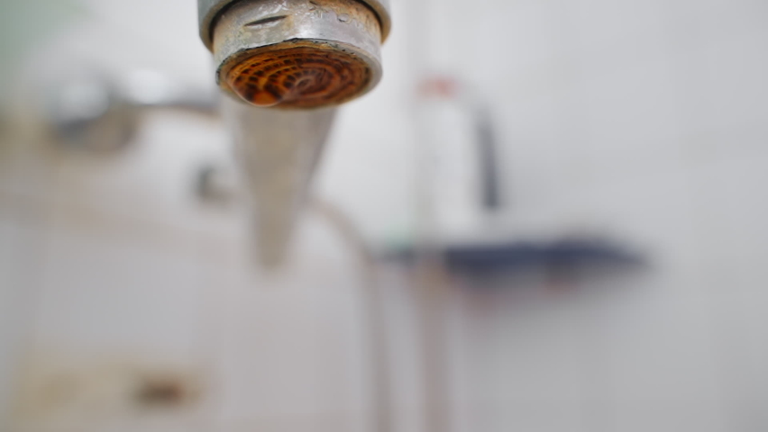 slow motion dripping tap. close up, drops of water falling down. dripping faucet. old plumbing covered limescale from hard water. close up dripping water tap in bathroom. plumbing problem. save water Royalty-Free Stock Footage #1096329655