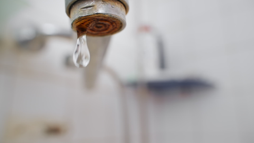 slow motion dripping tap. close up, drops of water falling down. dripping faucet. old plumbing covered limescale from hard water. close up dripping water tap in bathroom. plumbing problem. save water Royalty-Free Stock Footage #1096329655