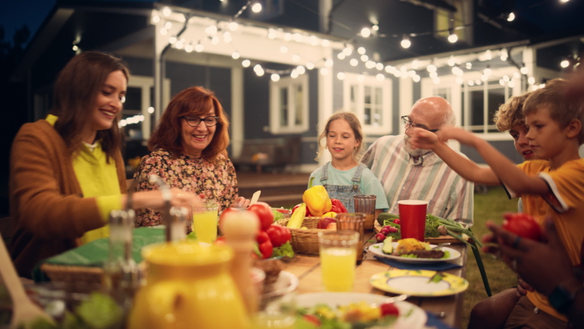 Group of Multiethnic Diverse People Having Fun, Sharing Stories with Each Other and Eating at Outdoors Dinner Party. Zoom Out Footage of a Family Gathered Outside Their Home on a Warm Summer Evening. | Shutterstock HD Video #1096329935